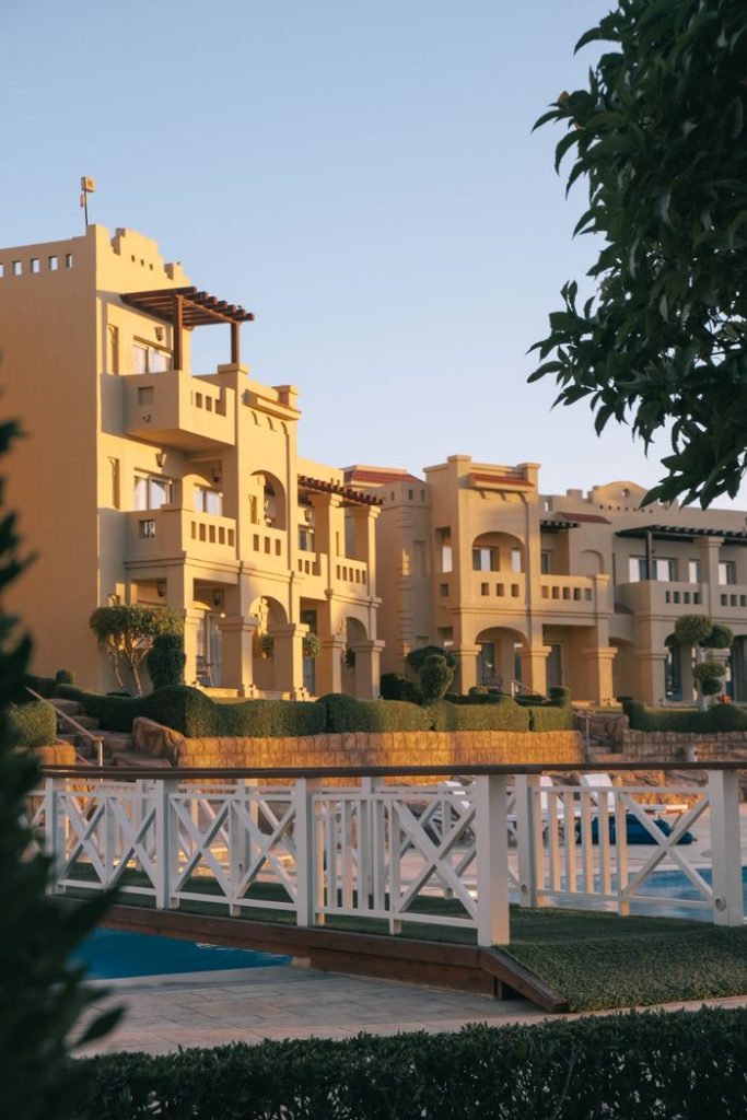 Elegant resort buildings with sunset hues, perfect for luxury travel themes.